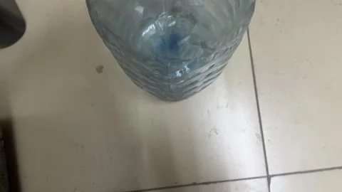Large empty plastic water bottle container standing on floor 库存影片 336977169