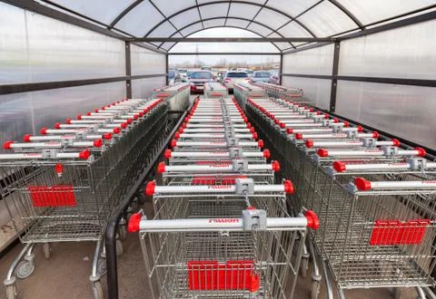 Large empty red shopping cart auchan store Fotos Stock