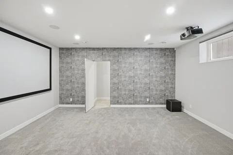 Large empty room with a projector screen and a door Stock Photos