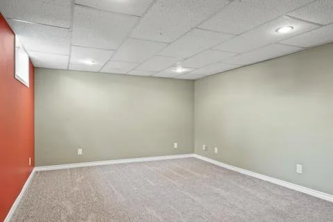 Large, empty room with a red wall Stock Photos