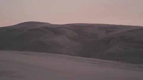 Large empty sand dune mountain on the horizon at sunset Stock Footage 148345323