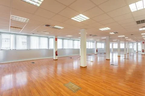 Large empty space with ceiling tiles, fluorescent lights, light brown laminate Photos