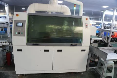 Large enclosed electronics production machine with conveyor and ventilation.. Fotos de archivo