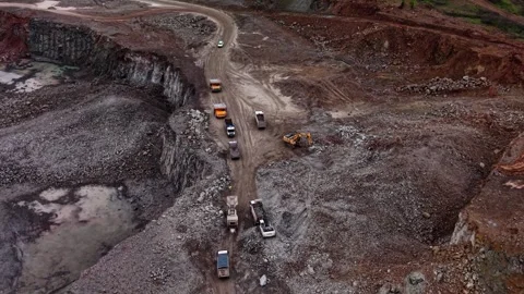 Large equipment working in industrial granite quarry near a road Stockbeeldmateriaal 337937286