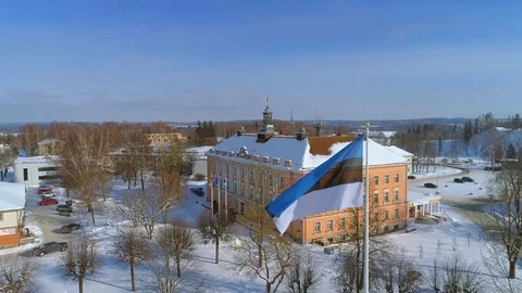 Large Estonian flag waving in front of a town hall Stock Footage 87197409
