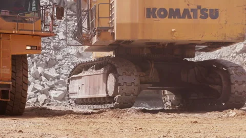 Large excavator depositing rubble onto the back of a heavy duty dump truck Stock Footage 241214888