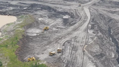 Large excavators dig up the earth and load it into dump trucks, paving the .. Stock Footage 332599829
