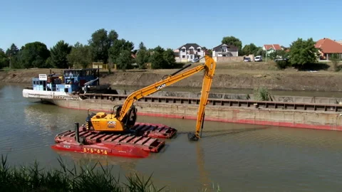 Large excavators engaged in cleaning of the riverbed of a river from the mud Video stock 137200339