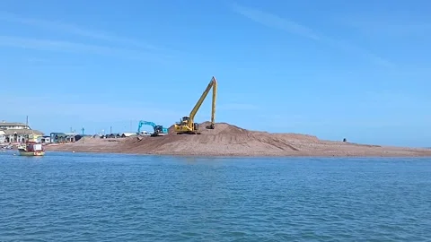 Large excavators moving sand at The Point, Teignmouth, Devon, England.  UK. Stock Footage 335414995