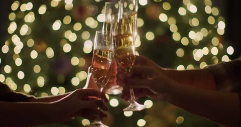 A large family clinks glasses of champagne against the backdrop of blurry Stock Footage 251009953
