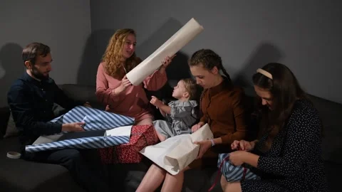 Large family happily wrapping multiple gifts in colorful paper Video stock 340065949