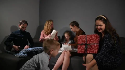 Large family happily wrapping multiple gifts in colorful paper Video stock 340065950