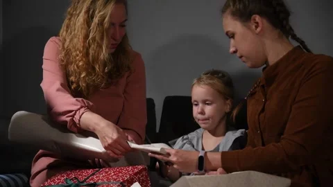 Large family happily wrapping multiple gifts in colorful paper Video stock 340065994