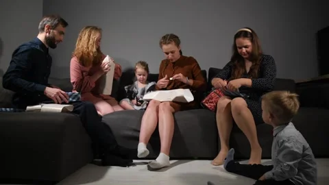 Large family happily wrapping multiple gifts in colorful paper Video stock 340066202