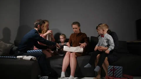Large family happily wrapping multiple gifts in colorful paper Vídeo Stock 340066216