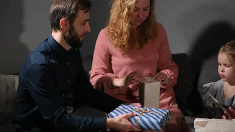 Large family happily wrapping multiple gifts in colorful paper Vídeo Stock 340066315