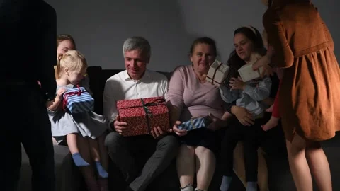 Large family happily wrapping multiple gifts in colorful paper Video stock 340066958