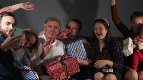 Large family happily wrapping multiple gifts in colorful paper Stock Footage 340067001