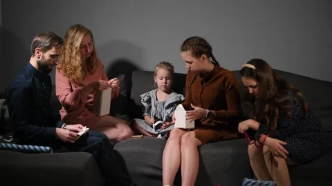 Large family happily wrapping multiple gifts in colorful paper together Stock Footage 340068589