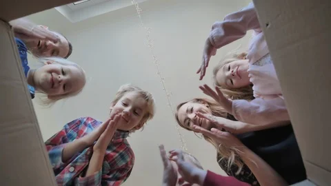 A large family opens the parcel and clap and get a gift. Stock Footage 126864415