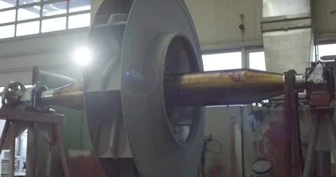 Large Fan Impeller on Horizontal Shaft, Backlit Factory Hall, Medium Shot Stock-Footage 340353955