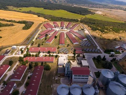 Large farm complex with circular layout and fields in the background Stock Photos