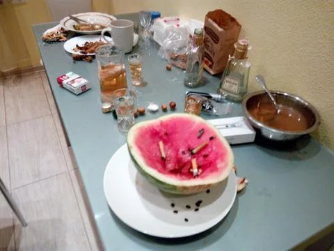 On large feasts, even a watermelon can become an ashtray Stock Photos