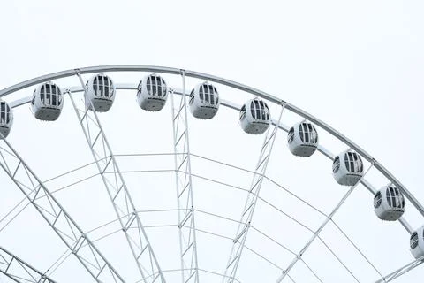 A large ferris wheel with a clock on top, great for travel and cityscapes 库存照片