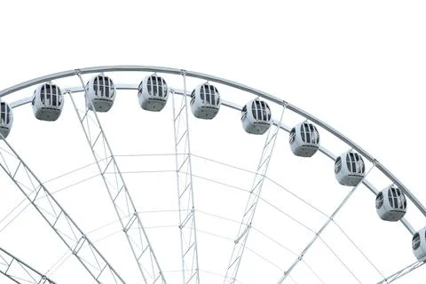 A large ferris wheel with a clock on top, suitable for use in images about time, Stock Photos