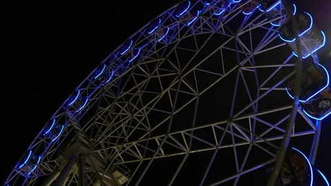 A large Ferris wheel rotates slowly on a dark evening. Stock Footage 282868197