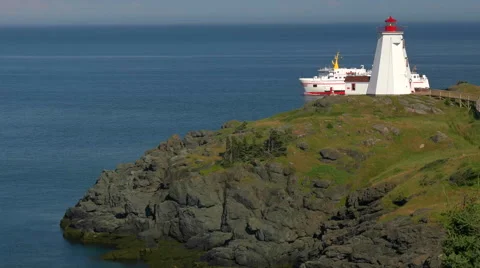 Large Ferry Boat passing by Atlantic Ocean Lighthouse at Sunset. Stock Footage 65324349