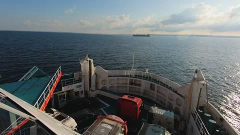 A large ferry cruises through open waters under a clear sky Stock Footage 288795367