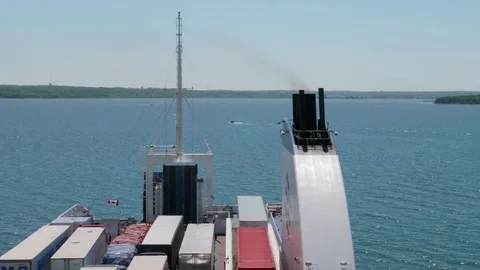 A large ferry sits in the harbor waiting to cross the ocean with cars Stock Footage 77364774