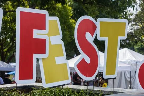 Large FEST sign displayed at fall festival Фото