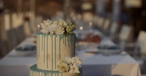 Large festive wedding white cake on a background of a table with snacks Stock Footage 123784447