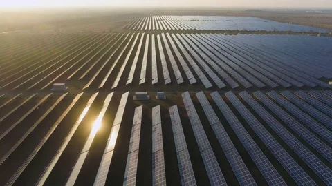 Large field of blue photovoltaic solar panels at sunset. Aerial view. Stock Footage