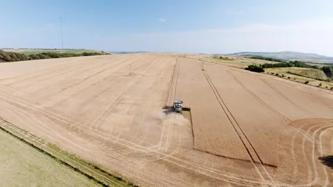 A large field with a tractor in the middle Stock Footage 297950705