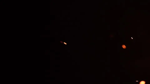 Large fiery embers swirling dynamically through dark space, slow motion overlay Stock Footage 337175457