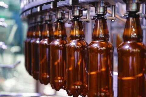 Large filling machine, the process of filling plastic bottles with various Stock Photos