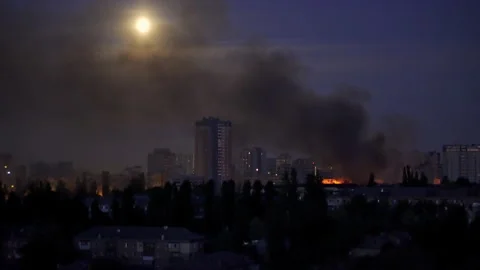 Large fire and thick black smoke rising over a residential area at night  Stockbeeldmateriaal 336187832