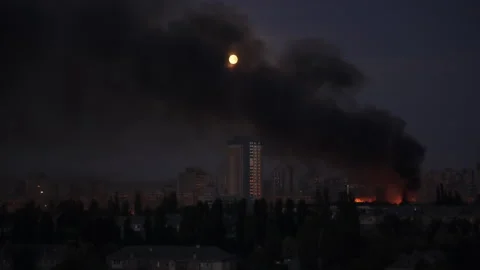 Large fire and thick black smoke rising over a residential area at night  Video stock 336188190