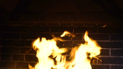 Large fire burning against a brick wall 4K Stock Footage 109422570