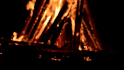 Large fire burning at night with smoke and sparks rising on a dark background Stock Footage 88225459