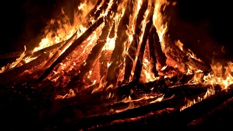 Large fire burning at night with smoke and sparks rising on a dark background Stock Footage 88225550