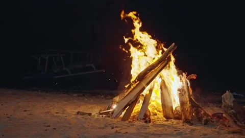 Large fire burning at night with smoke and sparks rising on a dark background Stock Footage 249548664