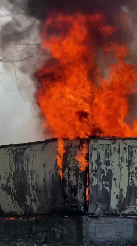 Large Fire with Flames Rising Above a Building After Shelling Stock Footage 346517934