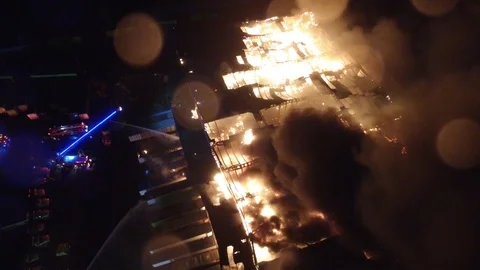 Large fire scene from above with flames raging throughout plant facility Video stock 92644174