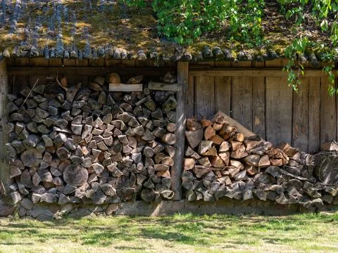 Large Firewood Stack Under Old Wooden Shed Roof Stock Photos