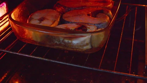 Large fish steaks are being baked in a hot oven Stock Footage 335261493