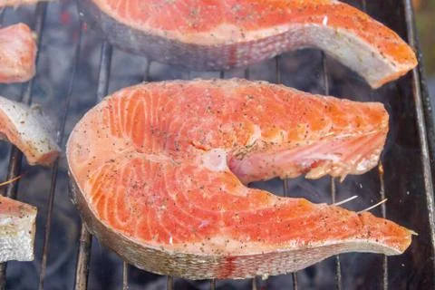 Large fish steaks fresh trout fried in spices on the grill Stock Photos